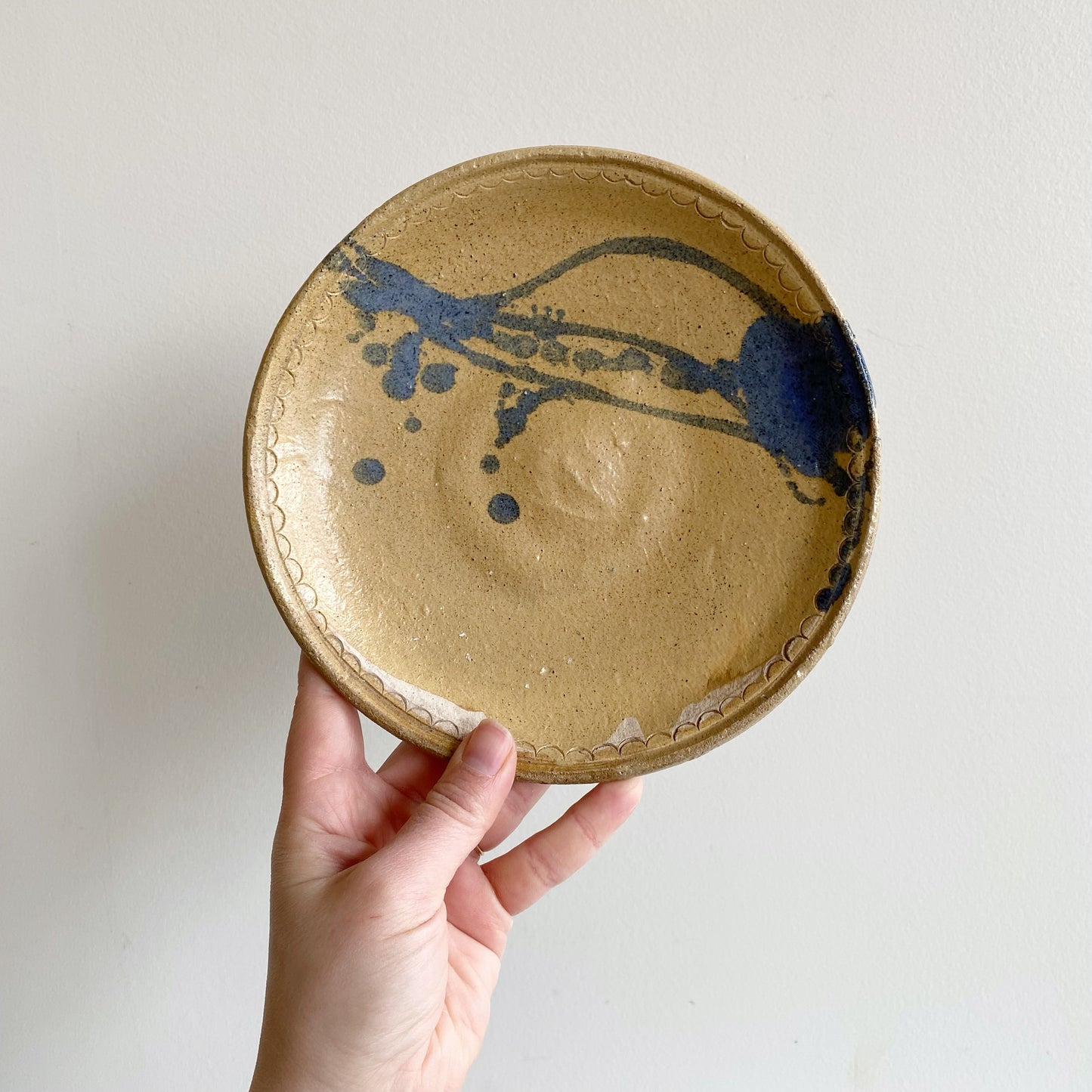 Vintage Pottery Plate with Blue Splatter Design